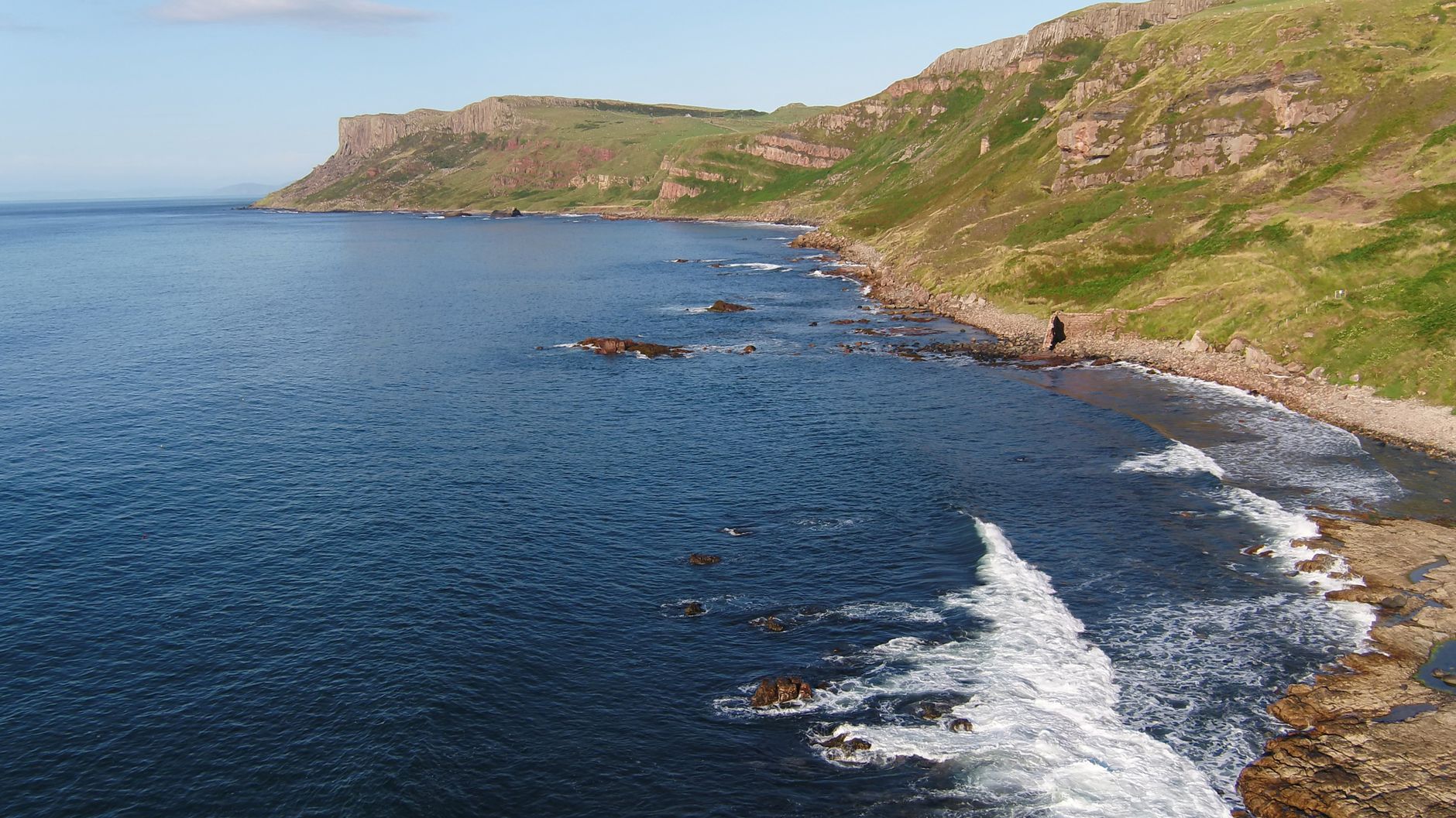 Coastal shoreline with misty ocean waters and rocky headlands